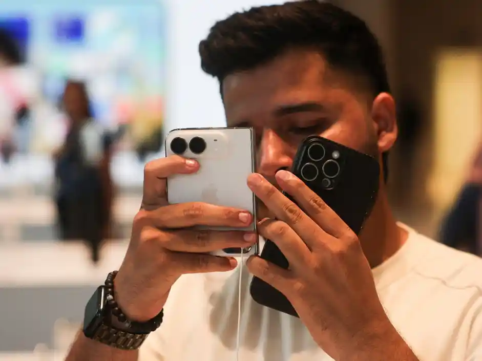 A customer uses iPhone Duo at the Apple store. (REUTERS)